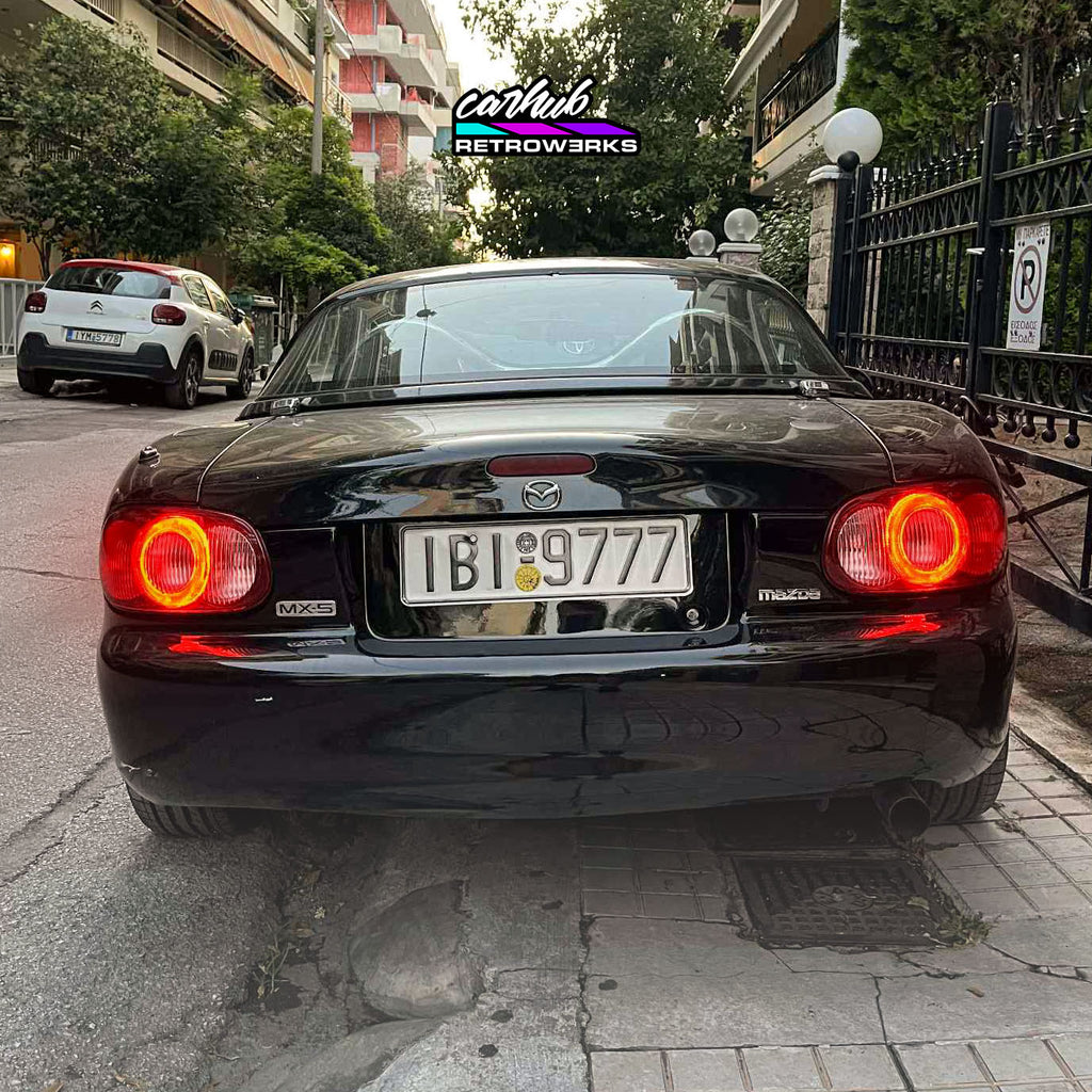 Pair of mazda mx5 nb nb2 halo taillights by carhub retrowerks installed on nb2 miata clear version no tint