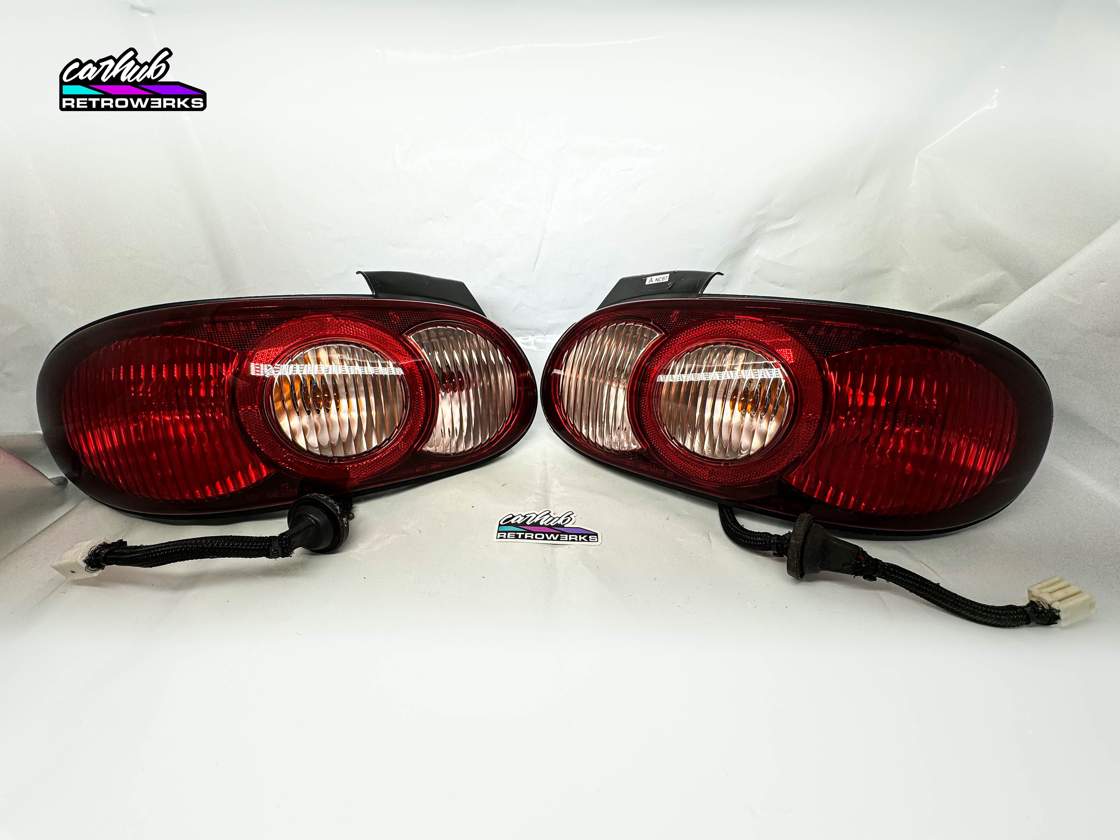 Pair of mazda mx5 nb nb2 halo taillights by carhub retrowerks installed on nb2 miata clear version no tint