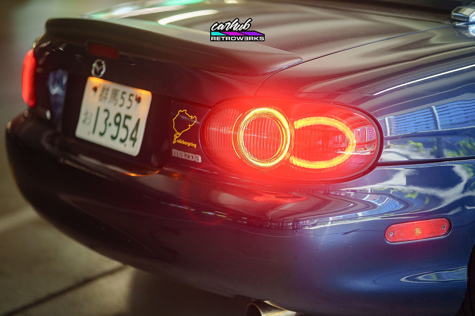 Customized OEM NB2 Mazda Miata Taillights with Halos and Strips installed on a NB close up