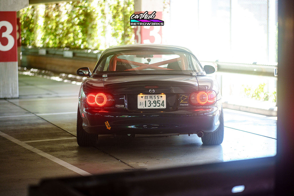 Customized OEM NB2 Mazda Miata Taillights with Halos and Strips installed on a NB close up