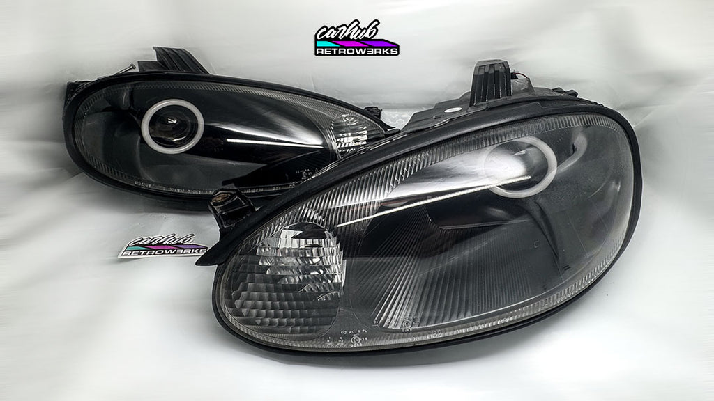 Set of 2.5 projector retrofitted headlights with white halos on nb1 nb mazda mx5 miata