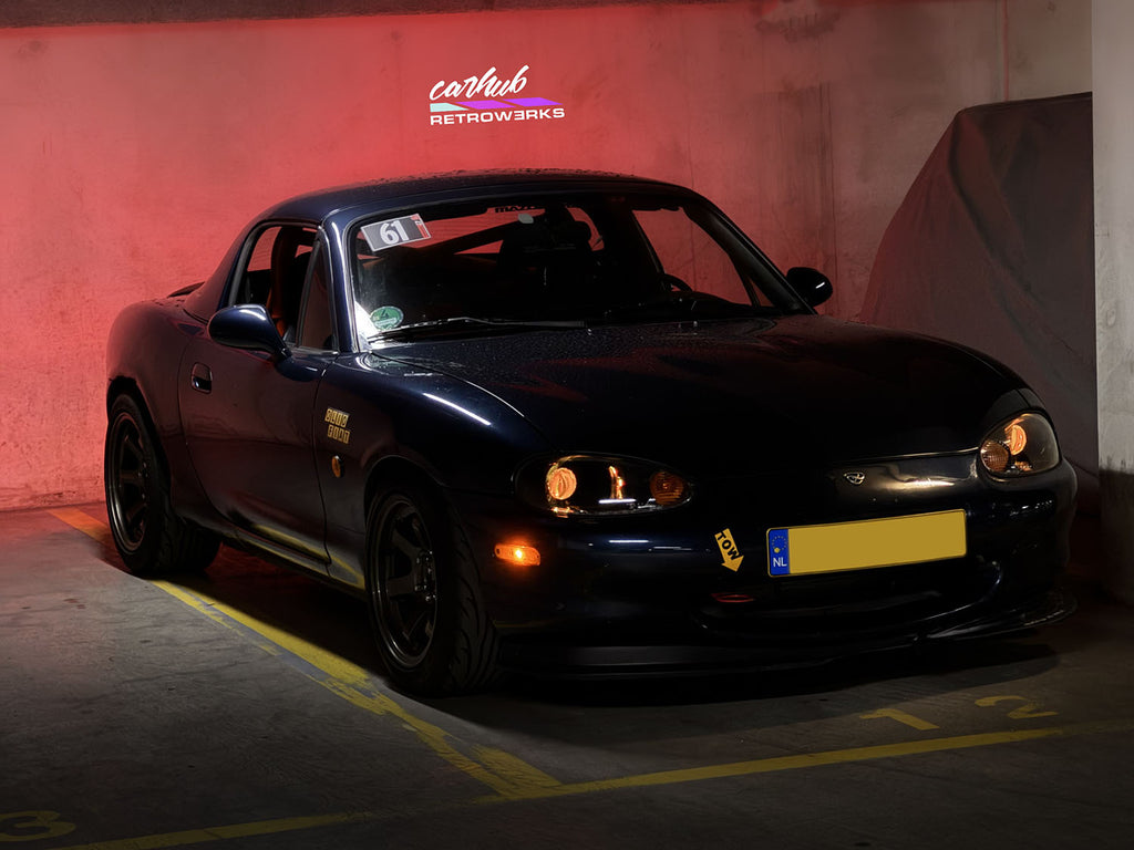 mazda mx5 nb nb1 miata mk2 with 3 inch projector retrofit gloss black interior and demon eyes set to orange